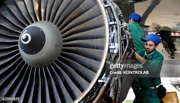 Atitech workers, work on a motor of one Alitalia airplane in Atitech Factory, in the airport of Capodichino in Naples.