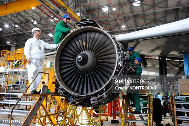 Atitech workers, work on a motor of one Alitalia airplane in Atitech Factory, in the airport of Capodichino in Naples.