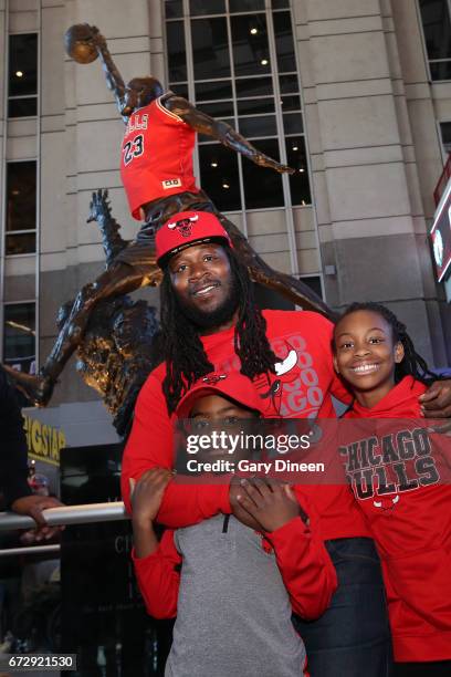 Chicago Bulls fans pose for a photo in front of the Michael Jordan statue outside of the United Center before Game Four during the Eastern...