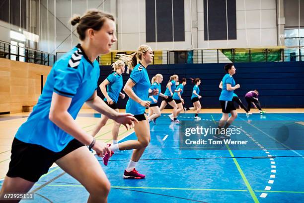 training session of a female handball team - warm up exercise indoor stock pictures, royalty-free photos & images