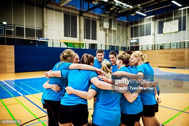 handball team demonstrating team spirit - team handball stock-fotos und bilder