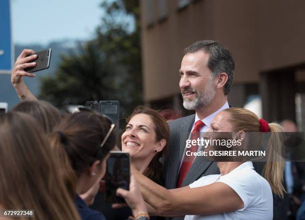 Spain's King Felipe VI poses for a selfie with students of the University of La Laguna during the visit of the laboratories of the University...