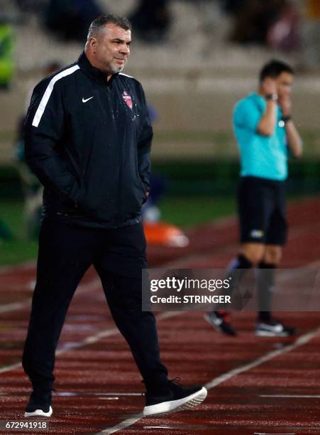 Ahli's Romanian coach Cosmin Olaroiu looks on during their AFC Champions League group B football match between Iran's Esteghlal and UAE's Al-Ahli on...