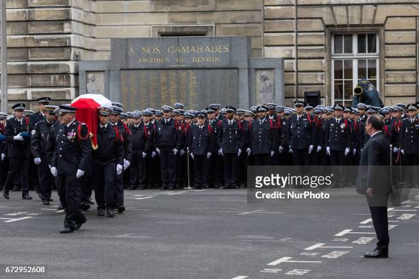 French police officers carry the flag-draped coffin during a ceremony honouring the policeman killed by a jihadist in an attack on the Champs...