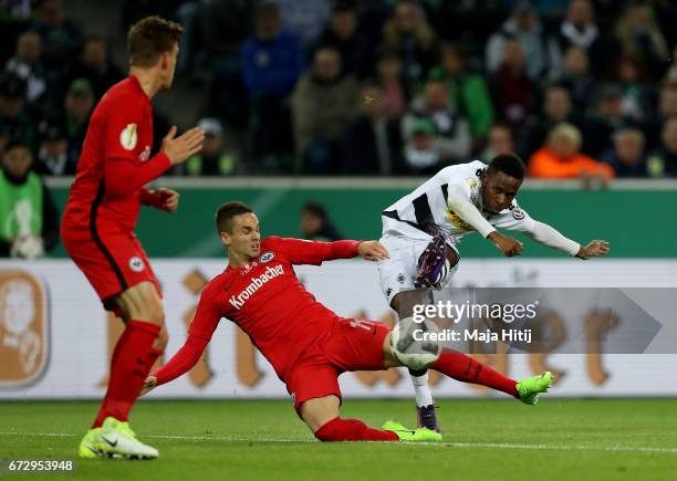 Ibrahima Traore of Moenchengladbach and Mijat Gacinovic of Frankfurt battle for the ball during the DFB Cup semi final match between Borussia...