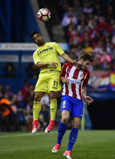 Atletico Madrid's midfielder Saul Niguez vies with Villarreal's midfielder Jaume Costa during the Spanish league football match Club Atletico de...