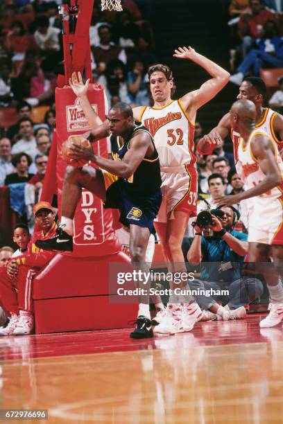 Antonio Davis of the Indiana Pacers rebounds against the Atlanta Hawks during a game played circa 1990 at the Omni in Atlanta, Georgia. NOTE TO USER:...