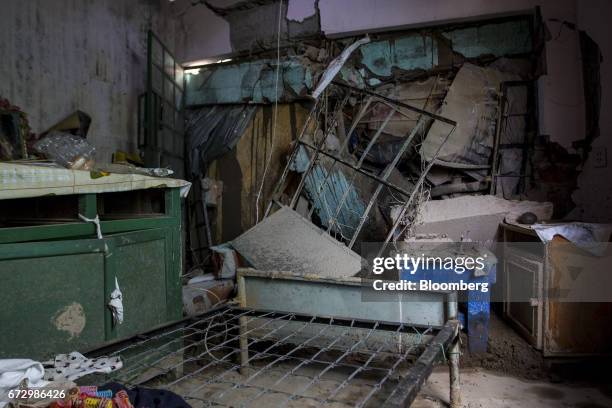 Broken furniture and cracked walls are seen in a bedroom of a home destroyed by massive floods in the town of Barba Blanca, Huarochiri Province, in...