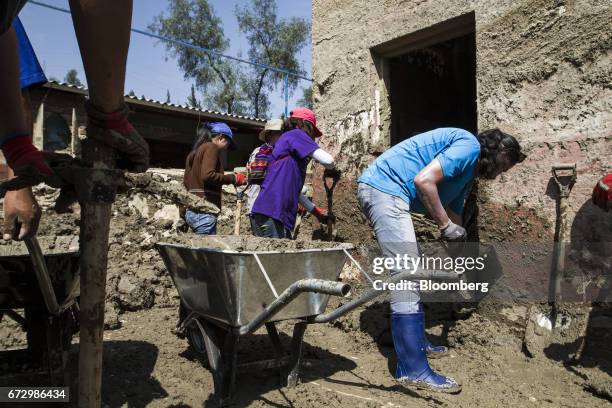 Volunteers work to rebuild homes destroyed by massive floods in the town of Barba Blanca, Huarochiri Province, in Lima, Peru, on Saturday, April 22,...