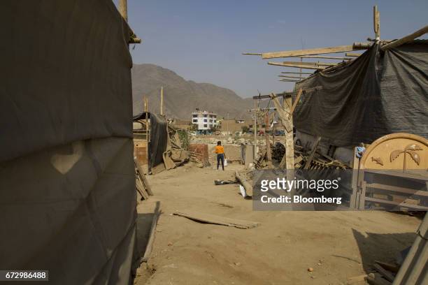 Displaced resident stands at a temporary housing camp near the destroyed village of Cajamarquilla, Chosica district in Lima, Peru, on Saturday, April...