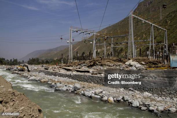 Worker operates a machine to rebuild parts of the Callahuanca hydroelectric power station impacted by massive floods in the district of Callahuanca,...