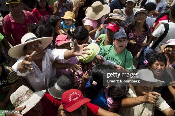 Displaced residents receive groceries at a temporary housing camp near the destroyed village of Carapongo, Chosica district in Lima, Peru, on...