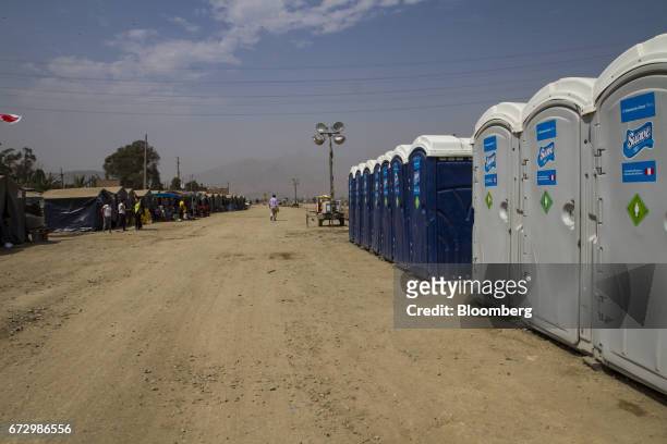 Portable toilets stand at a temporary housing camp near the destroyed village of Carapongo, Chosica district in Lima, Peru, on Saturday, April 22,...