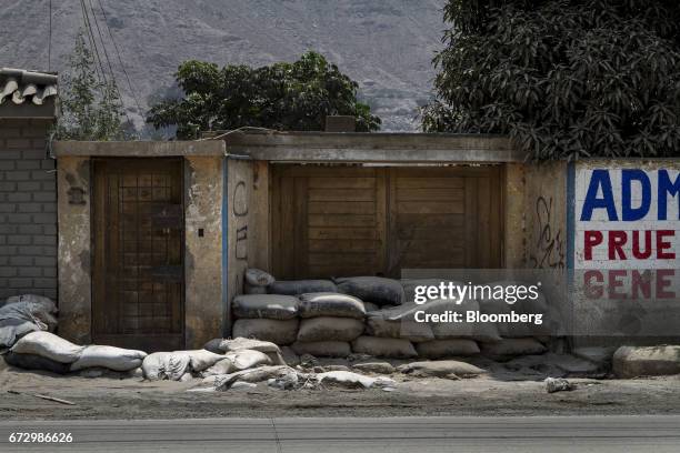 Sandbags sit outside a home in the town of La Cantutua, Chosica district in Lima, Peru, on Saturday, April 22, 2017. Peru's Finance Minister Alfredo...