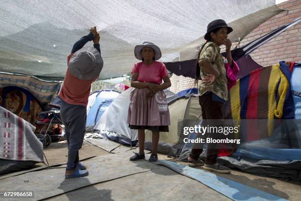 Displaced residents stand inside a temporary housing camp near the La Cantutua, Chosica district, in Lima, Peru, on Saturday, April 22, 2017. Peru's...