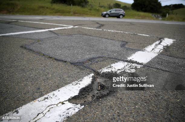 Pothole is visible on a road on April 25, 2017 in San Rafael, California. According to an analysis brief commissioned by the nonprofit nonpartisan...