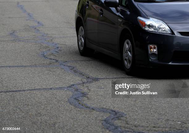 Cracked asphalt is seen on a road on April 25, 2017 in San Rafael, California. According to an analysis brief commissioned by the nonprofit...