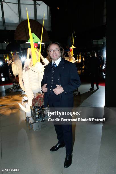 Bill Pallot poses in front the works of Jean-Paul Goude during the "Societe des Amis du Musee d'Art Moderne du Centre Pompidou" : Dinner Party. Held...