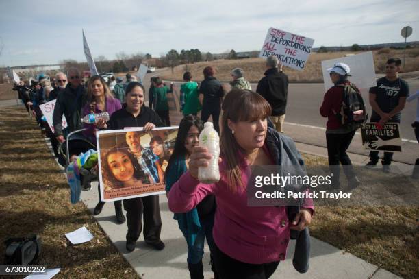Ana Sauzameda of Denver, followed by her daughter Andrea attended a rally outside the Immigration and Customs Enforcement office Feb. 12, 2015 on...