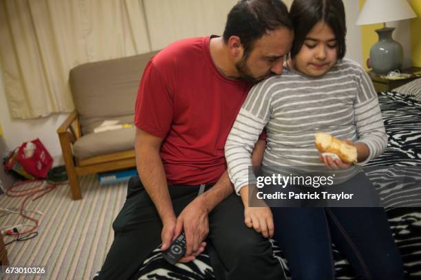 Arturo Hernandez Garcia shares a moment with his youngest daughter Andrea during a visit by his family on Feb. 20, 2015. While his family continues...