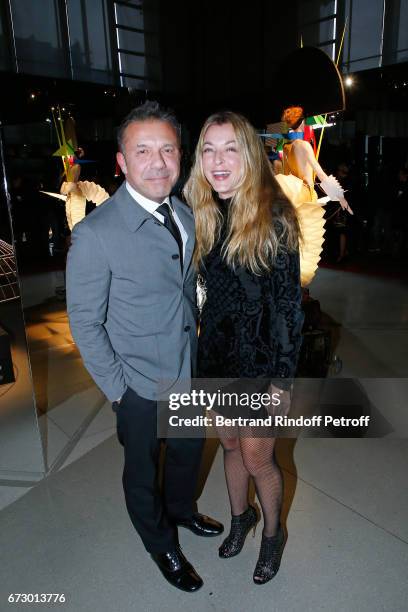 Olivier Widmaier Picasso and Arabelle Reille-Mahdavi pose in front the works of Jean-Paul Goude during the "Societe des Amis du Musee d'Art Moderne...