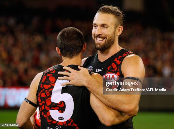 Cale Hooker of the Bombers celebrates with Brent Stanton of the Bombers during the 2017 AFL round 05 ANZAC Day match between the Essendon Bombers and...