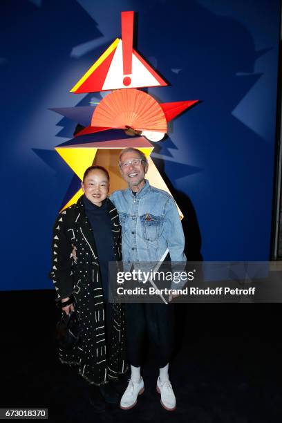 Jean-Paul Goude and his wife Karen pose in front the works of Jean-Paul Goude during the "Societe des Amis du Musee d'Art Moderne du Centre Pompidou"...