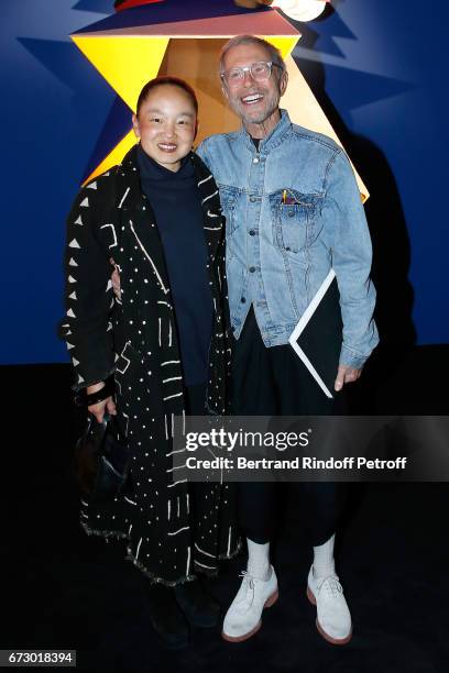 Jean-Paul Goude and his wife Karen pose in front the works of Jean-Paul Goude during the "Societe des Amis du Musee d'Art Moderne du Centre Pompidou"...