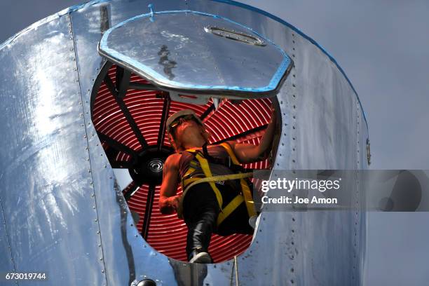 April 25: Artist Stephanie Shipman securing the Life sciences and Bio lab section to the top of the already mounted base of the spacecraft as the...