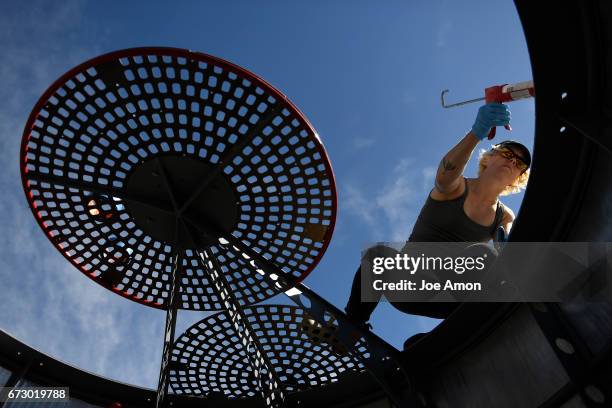 April 25: Artist Stephanie Shipman sealing the Life sciences and Bio lab section of the spacecraft as the team works to finish the installation of...