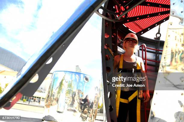 April 25: Artist Stephanie Shipman inside the Life sciences and Bio lab section ready to be lifted to the top of the already mounted base of the...