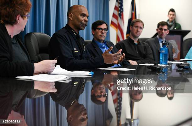 Denver police chief Robert White, second from left addresses questions posed to him by members of People Power to talk about the department's policy...