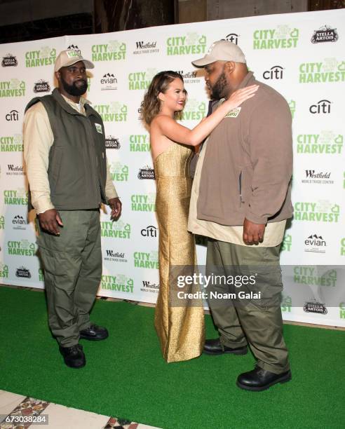 City Harvest driver Donte Moore, Chrissy Teigen and City Harvest driver Randy Headley attend the 23rd Annual City Harvest "An Evening of Practical...