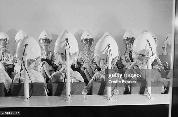 Contestants in the 1960 Miss World contest have their hair done at a beauty salon before the show, London, UK, 7th November 1960.