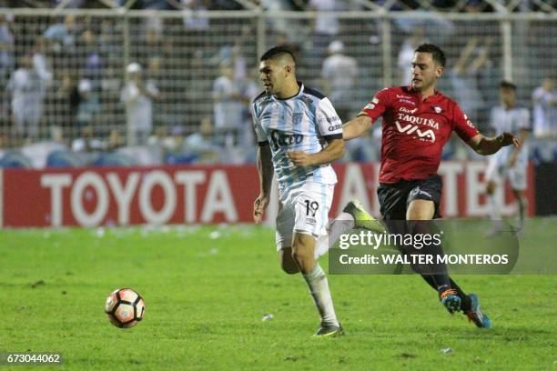 Argentinian Atletico Tucuman player David Barbona vies for the ball with Fernando Saucedo of Bolivian Wilstermann during their Libertadores Cup...
