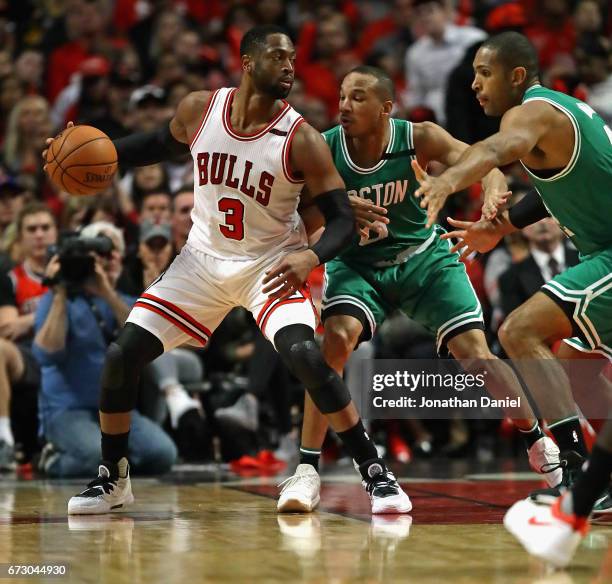 Dwyane Wade of the Chicago Bulls moves against Avery Bradley and Al Horford of the Boston Celtics during Game Four of the Eastern Conference...