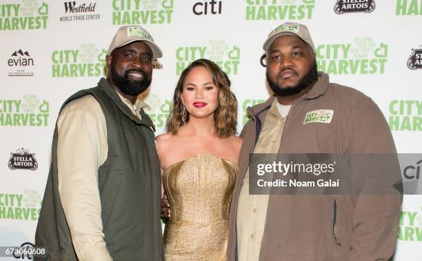 City Harvest driver Donte Moore, Chrissy Teigen and City Harvest driver Randy Headley attend the 23rd Annual City Harvest "An Evening of Practical...