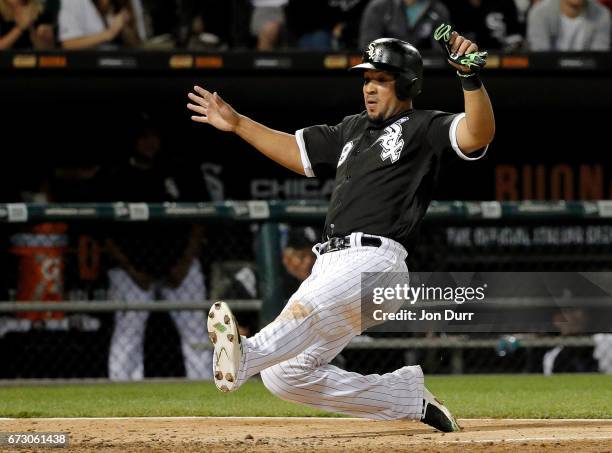 Jose Abreu of the Chicago White Sox slides in to home to score on an RBI double hit by Todd Frazier against the Kansas City Royals during the fifth...