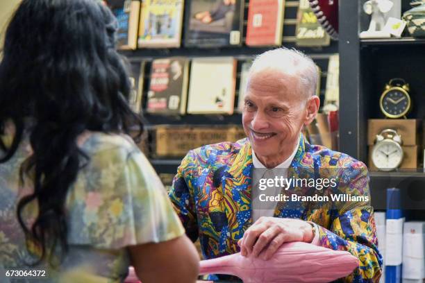 John Waters visits with a fan during his book signing for "Make Trouble" at Book Soup on April 25, 201