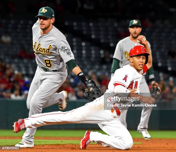 Andrelton Simmons of the Los Angeles Angels is tagged out by Jed Lowrie of the Oakland Athletics as he is caught in a run down in the fifth inning of...