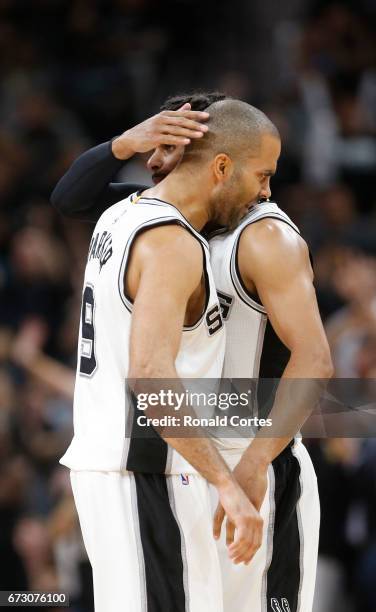 Patty Mills of the San Antonio Spurs receives a hug from Tony Parker of the San Antonio Spurs after a three against the Memphis Grizzlies in Game...