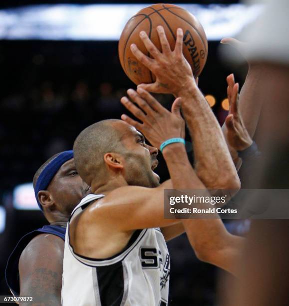 Tony Parker of the San Antonio Spurs looks to drive past Memphis Grizzlies defenders in Game Five of the Western Conference Quarterfinals during the...