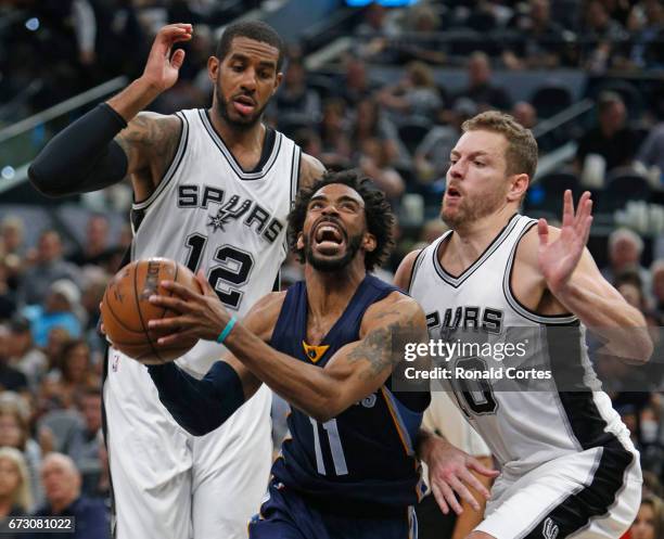 Mike Conley of the Memphis Grizzlies drives past David Lee of the San Antonio Spurs and LaMarcus Aldridge of the San Antonio Spurs in Game Five of...