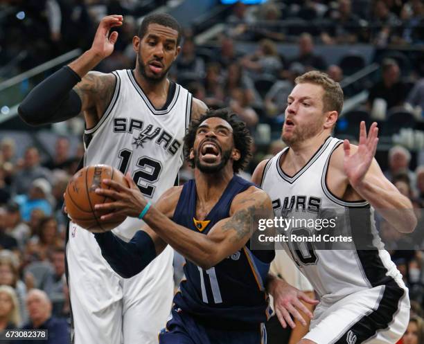 Mike Conley of the Memphis Grizzlies drives past David Lee of the San Antonio Spurs and LaMarcus Aldridge of the San Antonio Spurs in Game Five of...