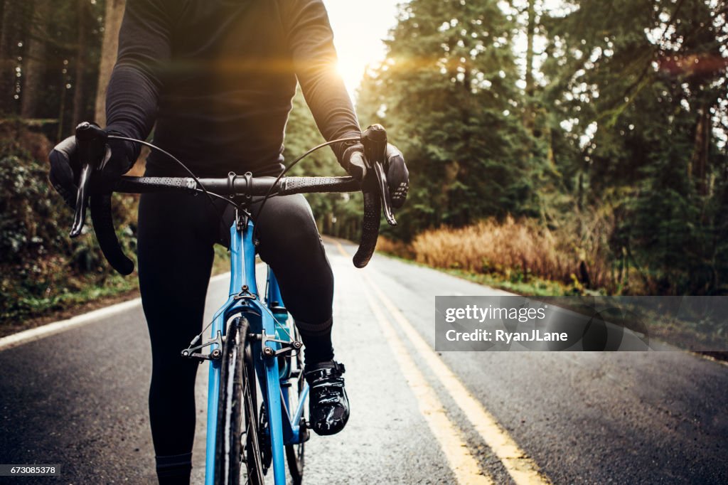 Cyclist Riding Mountain Road on Racing Bike