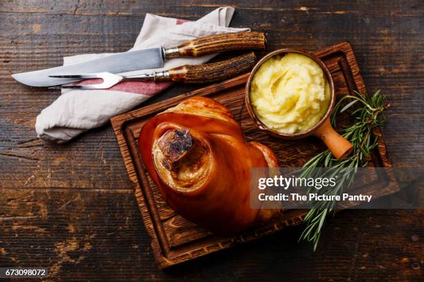 roasted pork knuckle eisbein with mashed potatoes on wooden cutting board - knuckle stock pictures, royalty-free photos & images