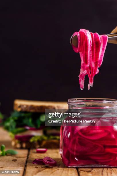 springtime feta sandwiches with avocado, pickled red onions and herbs like arugula, purslane and fresh mint served on a wooden board - red onion stock pictures, royalty-free photos & images