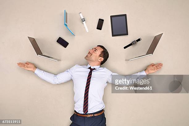 businessman juggling mobile devices - multitasking juggling stock pictures, royalty-free photos & images