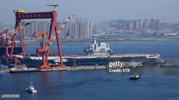 Type 001A, China's second aircraft carrier, is transferred from the dry dock into the water during a launch ceremony at Dalian shipyard in Dalian,...