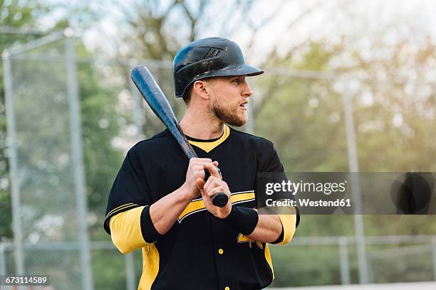 baseball player holding bat - baseball helmet stock pictures, royalty-free photos & images